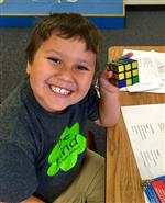 student with rubik's cube  
